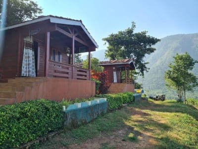 Wooden cottages with the Papikondalu hills in the background