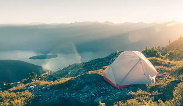 Tent on a hilltop at sunrise