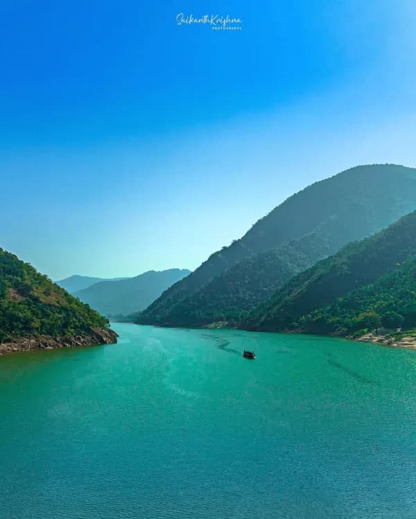 Boat on the turquoise Godavari between the Papikondalu hills